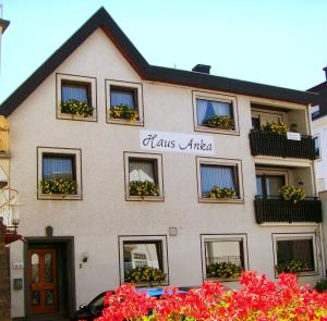 a white building with flowers in the windows at Haus-Anka in Cochem