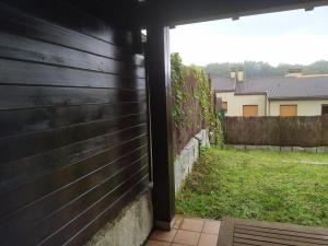 a view from the outside of a house with a fence at Precioso adosado a 5 minutos de la playa de Miño in Miño