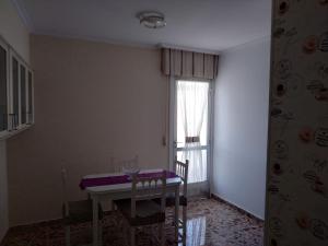 a dining room with a table and a window at Apartamento's Montiño in O Grove +4 photos