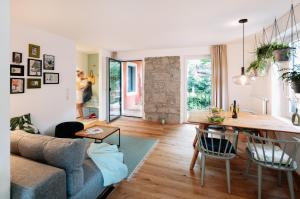 a living room with a couch and a table at Rotes Haus Bregenz Wald Wohnung in Bregenz