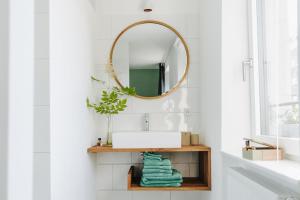 a bathroom with a sink and a mirror at Rotes Haus Bregenz Wald Wohnung in Bregenz