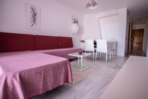 a living room with a couch and a table and chairs at Vistamojacar in Mojácar +69 photos