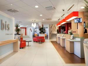 a reception area of a dental office with red chairs at ibis Paris Gare du Nord Château Landon 10ème in Paris