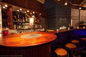 a bar with a wooden counter in a restaurant at Arctic Inn in Gratangen