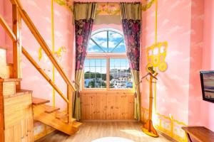 a room with a large window and a door at Red Praha Pension in Geoje 