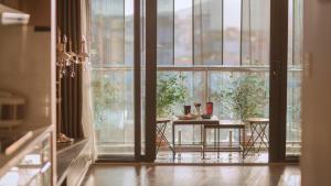 a room with a table in front of a window at Full House Condotel - Căn hộ 606 Dalat Center in Da Lat