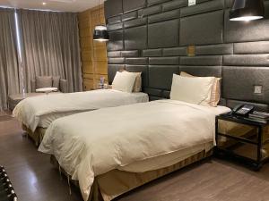Postel nebo postele na pokoji v ubytování U-Her Hotel