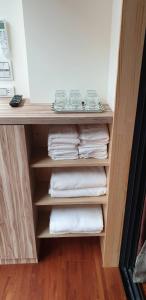 a towel rack with towels in a hotel room at Warm Home in Taitung City
