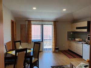 a kitchen and living room with a table and chairs at Privat Bartky in Vrbov
