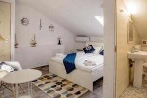 a bedroom with a bed and a sink and a table at SPOT Vama Veche in Vama Veche