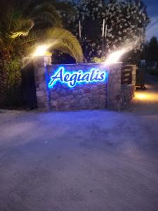 a sign on a wall that says acadias at night at Aegialis Apartments (Dimitros) in Vourvourou