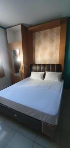Postel nebo postele na pokoji v ubytování Rumah Dempo Syariah + 1 fotografie
