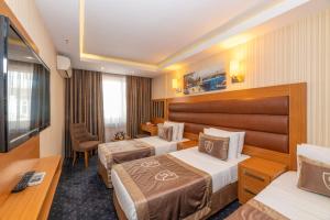 a hotel room with two beds and a desk at Regno Hotel in Istanbul +71 photos