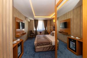 a hotel room with a bed and a television at Regno Hotel in Istanbul