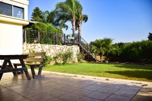 a park bench sitting in front of a house at Family Zimmer in Hosha‘ya