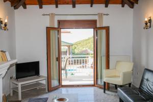 a living room with a sliding glass door leading to a patio at Takis Studios in Punta