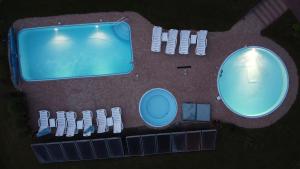 an overhead view of a swimming pool and a group of chairs at Agroturystyka Willa Maria in Bystrzyca Kłodzka
