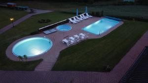 an overhead view of a swimming pool in a yard at Agroturystyka Willa Maria in Bystrzyca Kłodzka +16 photos
