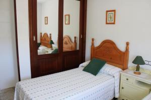 a bedroom with two beds and a mirror at Apartamentos Os Cerros in Portonovo +51 photos