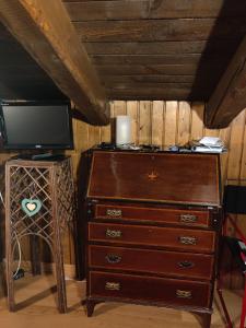a wooden dresser with a television and a dresser with a dresser at Chalet Chamois in Courmayeur