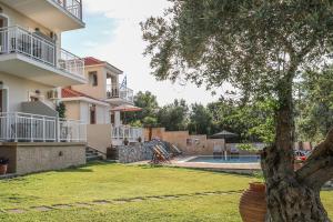 a view of a house with a tree in the yard at Takis Studios in Punta