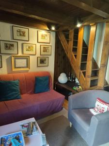 a living room with a couch and a staircase at Chalet Chamois in Courmayeur