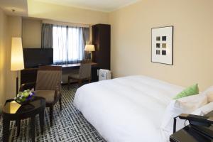 Postel nebo postele na pokoji v ubytování Kanazawa New Grand Hotel Prestige