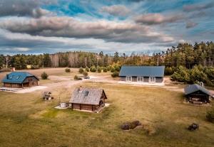 an aerial view of a house and a barn at Brīvdienu māja "Avotiņš" in Līvāni