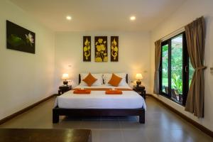 En eller flere senge i et værelse på Wapi Resort