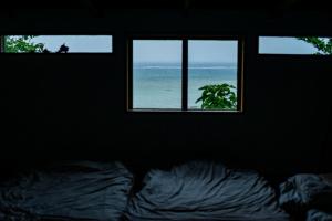Postel nebo postele na pokoji v ubytování Villa SACHIIBARU 浜辺の茶屋 の 宿