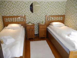 2 camas individuales en una habitación con 2 mesitas de noche en Havsnära 1700-tals Timmerstuga, en Ängelholm