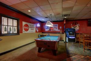 a room with a pool table and a soda machine at Ramada by Wyndham Macon in Macon