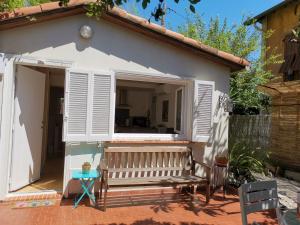 a small house with a window and a bench at Nice - Charming little house with terrace in Nice