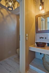 a bathroom with a sink and a mirror at Lux View Suites in Kyra Panagia