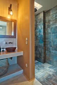 a bathroom with a sink and a mirror at Lux View Suites in Kyra Panagia