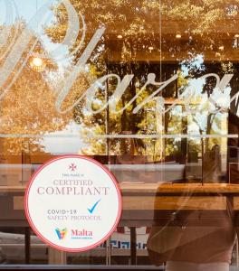 a sign in the window of a store at Plaza Regency Hotels in Sliema