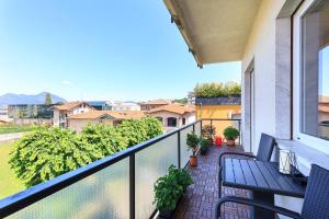 a balcony with two benches and a view of a city at Vespucci Boutique in Stresa