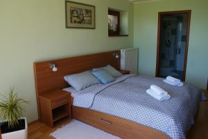 a bedroom with a bed with two towels on it at Apartmány Kvetná in Rajecké Teplice