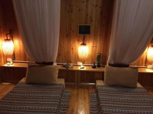 two beds in a room with curtains and lights at D&D Eco Sapa in Sapa