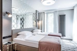 Posteľ alebo postele v izbe v ubytovaní Hotel Traugutta3