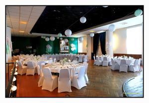 a banquet hall with white tables and white chairs at Hôtel De France - Restaurant L'insolite in Douarnenez