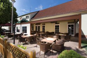 a patio with tables and chairs in front of a restaurant at Hotel & Gasthaus Zum Eichenkranz in Luckenwalde
