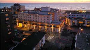 a city with a large building with lights on at Beach House Parallel in Noordwijk