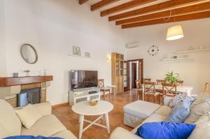 a living room with a couch and a fireplace at Villa Astur in Binibeca