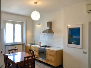 a kitchen with a table and a stove top oven at LoLè Apartment - Ancona in Ancona