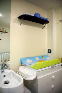 a bathroom with a baby crib on top of a toilet at Casa mobile Gustocamp a Cavallino Treporti in Cavallino-Treporti