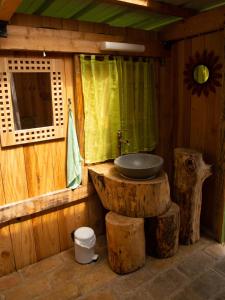 a bathroom with a sink on top of a log at Tipi / Nature / Détente in Bragny-sur-Saône