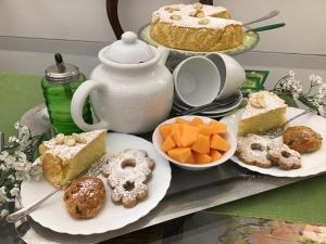 a tray filled with different types of cakes and pastries at B&B Lercari in Genoa