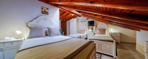 two beds in a bedroom with wooden ceilings at La Paloma Hotel in Antalya
