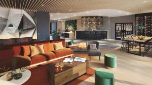 a living room and kitchen with a couch and a table at Hotel & Spa Suiten FreiWerk in Stolberg